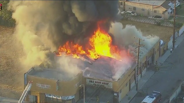 Commercial building fire engulfs auto body shop in Compton