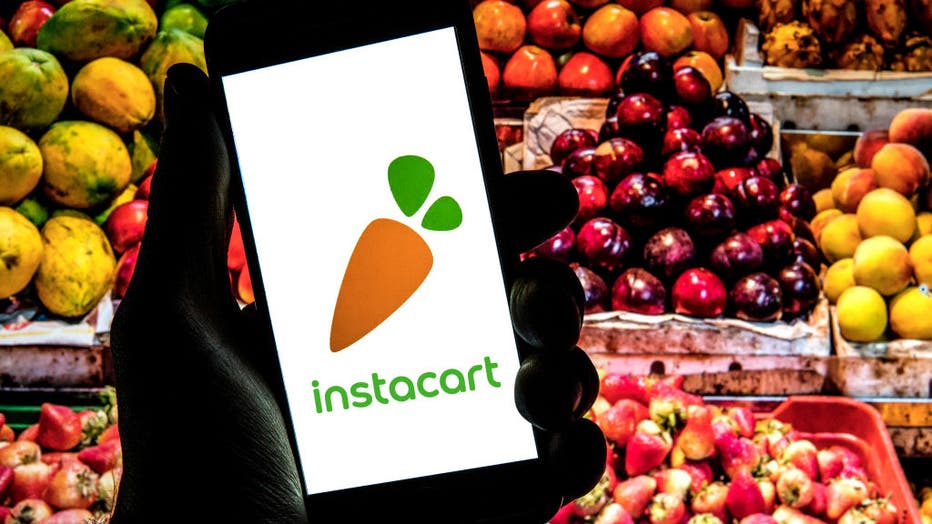 In this photo illustration a Instacart logo seen displayed
