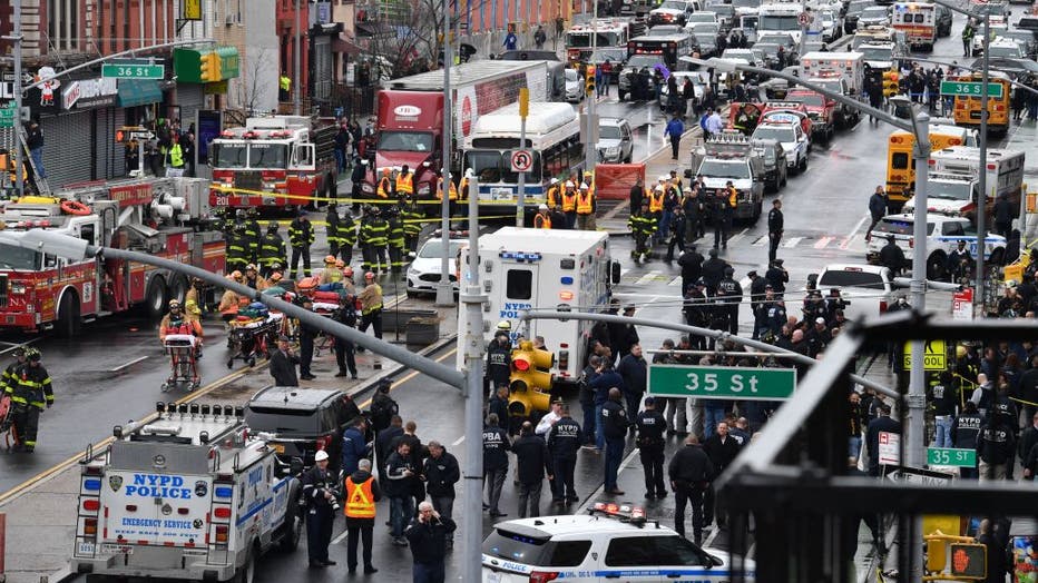Emergency vehicles and the New York Police Department crowd the streets after several people were injured during a rush-hour shooting at a subway station in the New York borough of Brooklyn on April 12, 2022. (Photo by ANGELA WEISS/AFP via Getty Images)