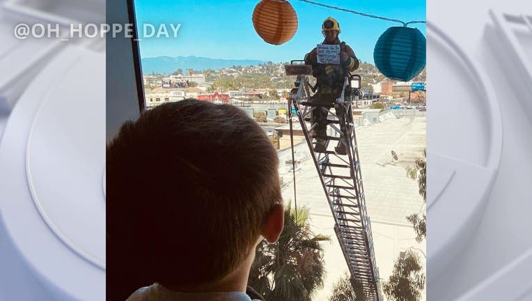 A Los Angeles firefighter encourages a little boy ahead of a serious medical procedure. PHOTO: @Oh_Hoppe_Day