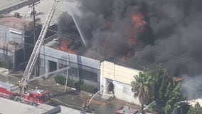 Massive fire burns through at least 5 Boyle Heights buildings, 4 firefighters hurt