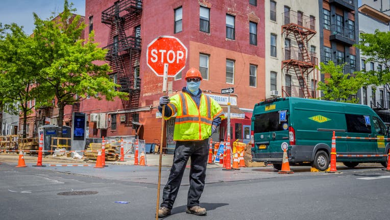 Construction workers wearing protective face masks on site.