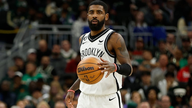 Kyrie Irving #11 of the Brooklyn Nets dribbles the basketball up court during the second half of the game against the Milwaukee Bucks at Fiserv Forum on October 26, 2022. Photo by John Fisher/Getty Images