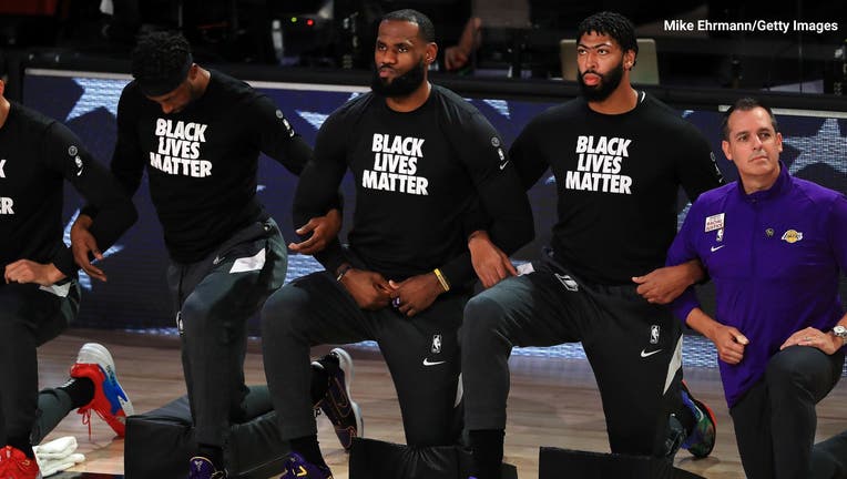LeBron James #23 of the Los Angeles Lakers along with Anthony Davis #3 of the Los Angeles Lakers kneel during the National Anthem on September 4, 2020. PHOTO: Mike Ehrmann/Getty Images.