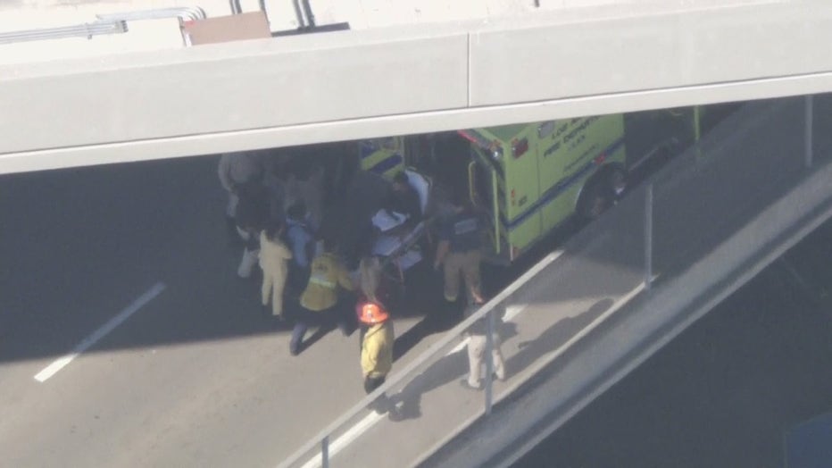 Pursuit suspect placed in ambulance following hour-long standoff outside LAX.