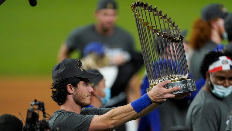 Cody Bellinger #35 of the Los Angeles Dodgers holds the Commissioners Trophy after defeating the Tampa Bay Rays 3-1 in Game Six to win the 2020 MLB World Series. (Photo by Cooper Neill/MLB Photos via Getty Images)