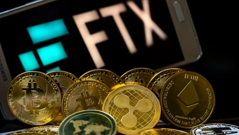 FTX logo with crypto coins with 100 Dollar bill are displayed for illustration. FTX has filed for bankruptcy in the US, seeking court protection as it looks for a way to return money to users. (Photo illustration by Jonathan Raa/NurPhoto via Getty Images)