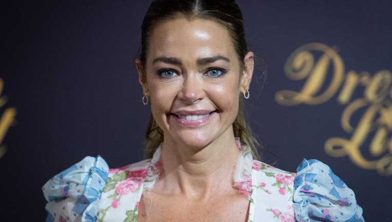 Media photo of actress Denise Richards, smiling in a floral top.