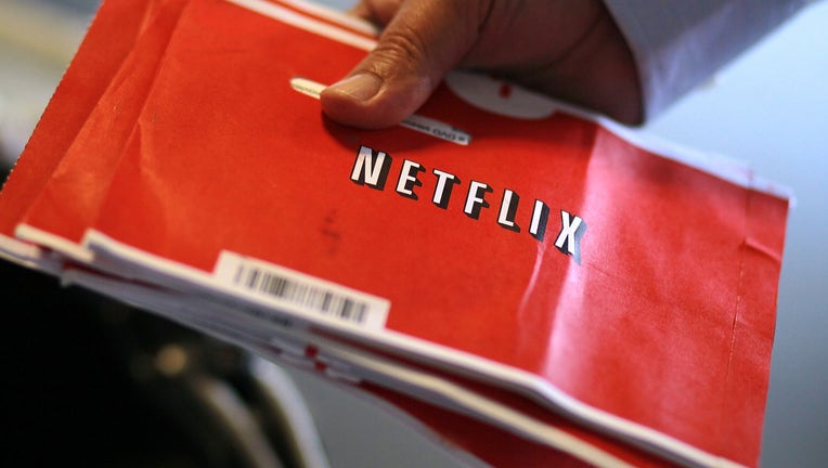 A U.S. Postal worker holds a stack of Netflix envelopes at the U.S. Post Office sort facility on October 24, 2011 in San Francisco, California. Online movie rental company Netflix reported third quarter earnings of $62.5 million, or $1.16, per share compared to $38 million, or 70 cents per share one year ago. (Photo by Justin Sullivan/Getty Images)