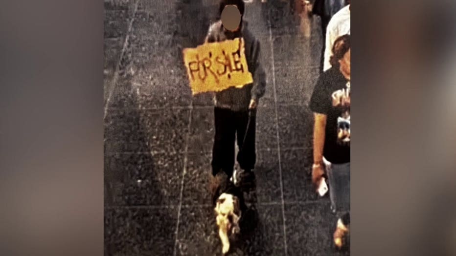 A dog owner shared a photo of what is believed to be his missing English bulldog with stranger holding a sign that reads "For Sale."