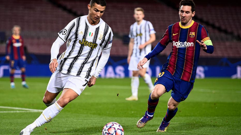 Cristiano Ronaldo (L) of Juventus FC is challenged by Lionel