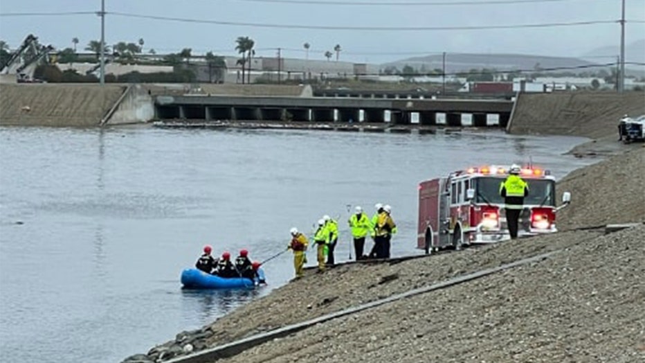 Crews actively working to rescue three individuals who were swept downstream by the current.