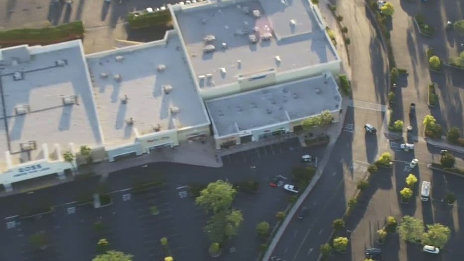 A man accused of carrying an axe at a shopping center in Compton was shot and killed by Los Angeles County deputy.