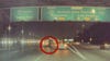 Tesla dashcam captures pedestrian walking across 5 Freeway during traffic
