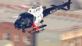 Santa ditches sleigh, gets lift from LAPD chopper to deliver presents to kids in hospital