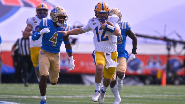Quarterback Nick Patti #12 of the Pittsburgh Panthers runs for yardage against defensive back Stephan Blaylock #4 of the UCLA Bruins during the first half of the Tony the Tiger Sun Bowl game at Sun Bowl Stadium on December 30, 2022. (Photo by Sam Wasson/Getty Images)