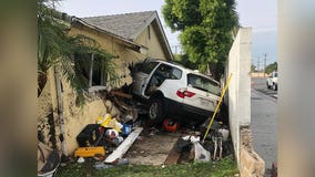 Family displaced after car plows into Huntington Beach home, narrowly missing mom and baby