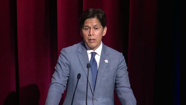 Kevin de León stands in back of LA City Council Chambers; Prompting protest from his own peers