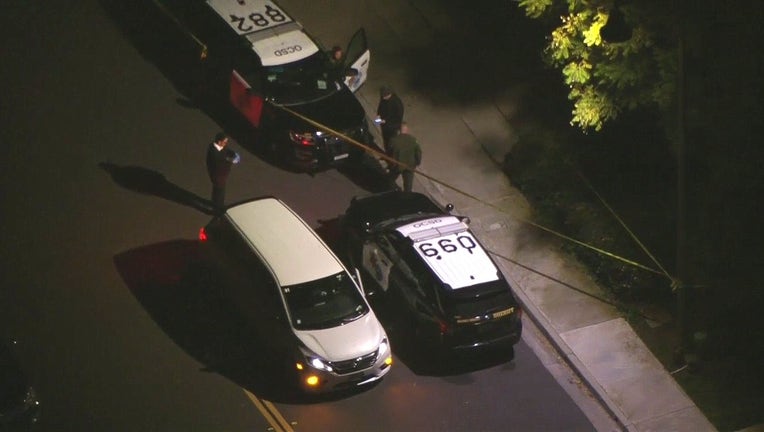 Aerial shot from SkyFOX shows two police cruisers and a van next to yellow police tape.