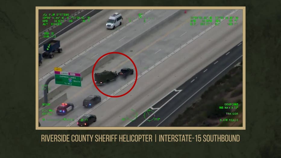 Police helicopter camera footage of a police chase involving a dark pickup truck and dozens of deputy cruisers and armored vehicles.