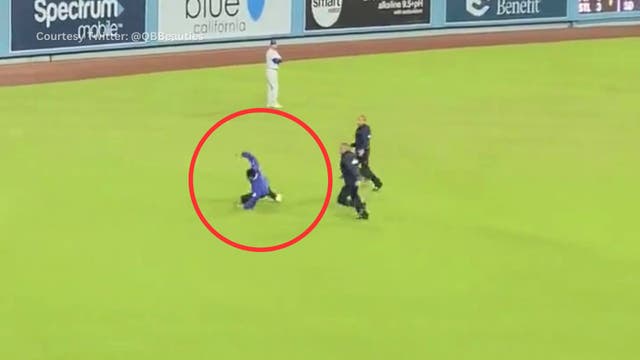Dodgers fan trips, gets tackled on field
