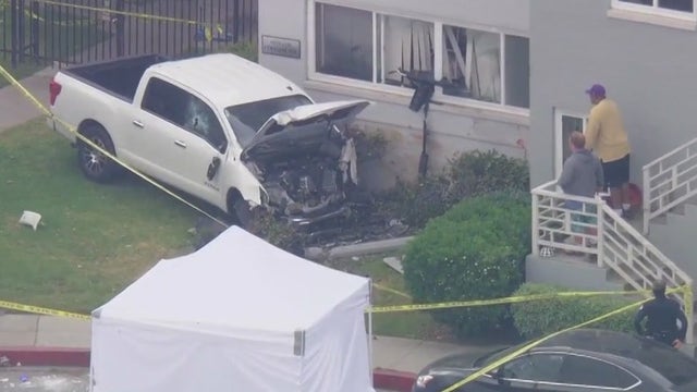 Mother killed, child hospitalized after car crashes into Mid-Wilshire building near school
