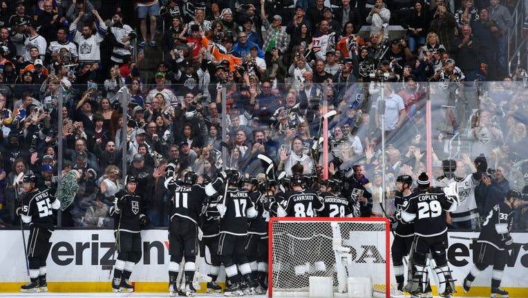 Trevor Moore #12 of the Los Angeles Kings celebrates his goal winning goal with teammates during overtime against the Edmonton Oilers in Game Three of the First Round of the 2023 Stanley Cup Playoffs. (Photo by Juan Ocampo/NHLI via Getty Images)