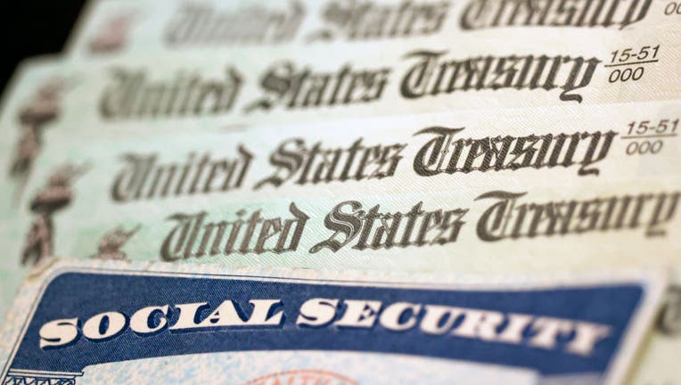 In this photo illustration, a Social Security card sits alongside checks from the U.S. Treasury on October 14, 2021 in Washington, DC. The Social Security Administration announced recipients will receive an annual cost of living adjustment of 5.9%, the largest increase since 1982. The larger increase is aimed at helping to offset rising inflation. (Photo illustration by Kevin Dietsch/Getty Images)