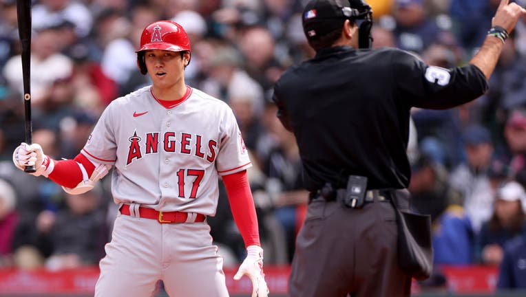 Umpire Pat Hoberg #31 calls Shohei Ohtani #17 of the Los Angeles Angels for a pitch clock violation during the sixth inning against the Seattle Mariners at T-Mobile Park on April 05, 2023 in Seattle, Washington. (Photo by Steph Chambers/Getty Images)