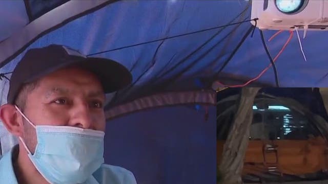 Big screen projector installed in homeless person's tent in Hollywood
