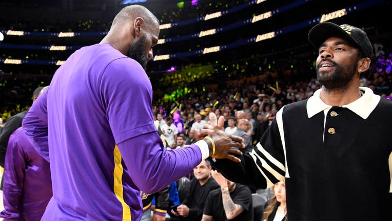 Kyrie Irving greets LeBron James of the Los Angeles Lakers as he attends a basketball game between Los Angeles Lakers and Memphis Grizzlies Round 1 Game 6 of the 2023 NBA Playoffs. (Photo by Kevork Djansezian/Getty Images)