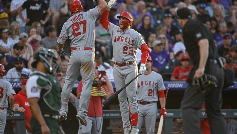 Mike Trout #27 of the Los Angeles Angels celebrates with Brandon Drury #23 after hitting a third inning solo homerun in a game against the Colorado Rockies. (Photo by Dustin Bradford/Getty Images)