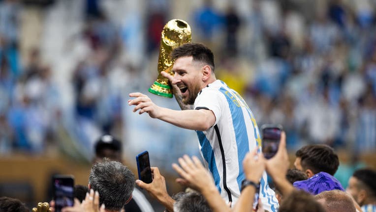 Lionel Messi of Argentina celebrates with the World Cup Trophy after the FIFA World Cup Qatar 2022 Final match. (Photo by Simon Bruty/Anychance/Getty Images)