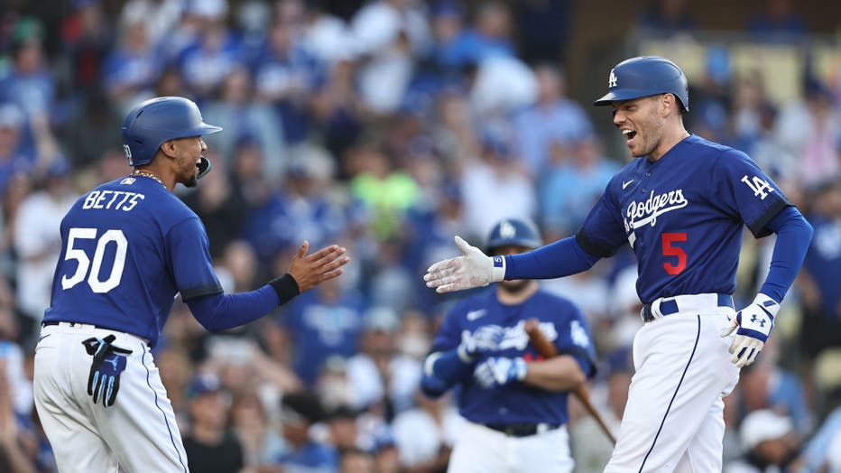 Freddie Freeman #5 of the Los Angeles Dodgers celebrates with teammate Mookie Betts #50 after hitting a two-run home run against the Pittsburgh Pirates. (Photo by Michael Owens/Getty Images)