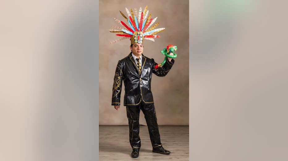 Man stands in center frame wearing his custom prom outfit