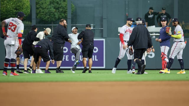 Fans rush field, incident ends with Atlanta Braves star Ronald Acuña Jr. knocked to ground