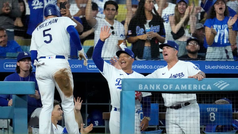 Manager Dave Roberts #30 of the Los Angeles Dodgers celebrates Freddie Freeman #5 scoring a run against Milwaukee Brewers. (Photo by Kevork Djansezian/Getty Images)