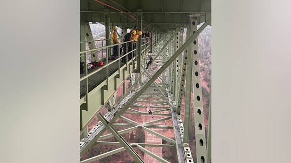 Teen found dangling from California's highest bridge rescued