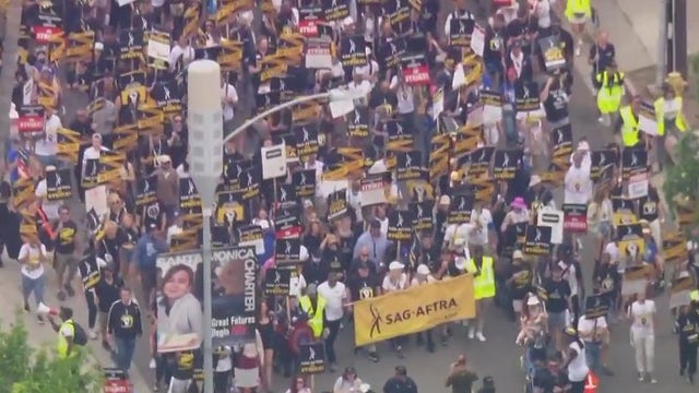 Striking actors, writers go on solidarity march through Hollywood