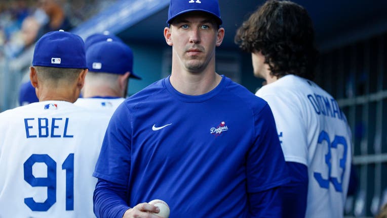 Los Angeles Dodgers pitcher Walker Buehler (21) walks in the dugout prior to a regular season game between the Minnesota Twins and Los Angeles Dodgers. (Photo by Brandon Sloter/Icon Sportswire via Getty Images)