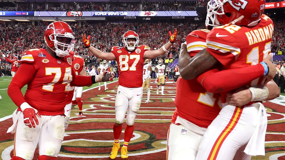 Mecole Hardman Jr. #12 of the Kansas City Chiefs celebrates with Patrick Mahomes #15 and Travis Kelce #87 and teammates after catching the game-winning touchdown pass to defeat the San Francisco 49ers 25-22 during Super Bowl LVIII at Allegiant Stadium on Feb. 11, 2024, in Las Vegas, Nevada. (Photo by Ezra Shaw/Getty Images)