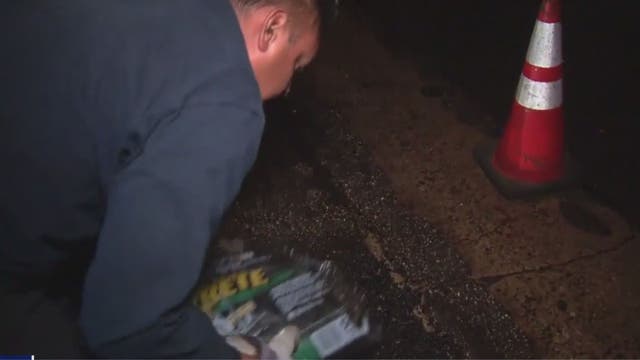 Couple fills potholes in Compton to help drivers
