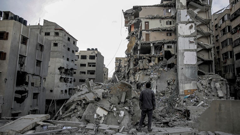 Palestinian-man-stands-in-rubble.jpg