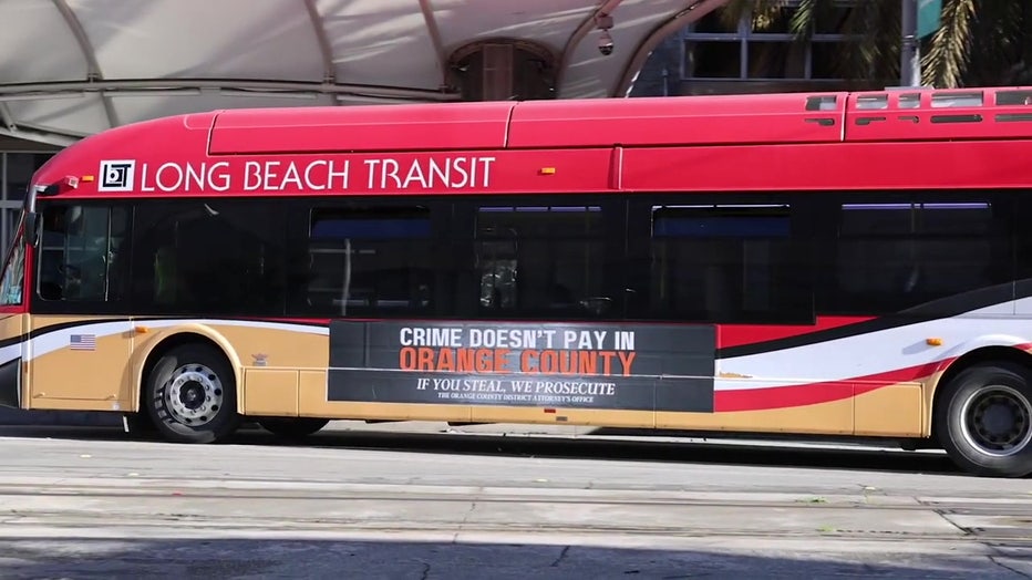 A public transit bus with a campaign poster that reads, "Crime doesn't pay in Orange County. If you steal, we prosecute."