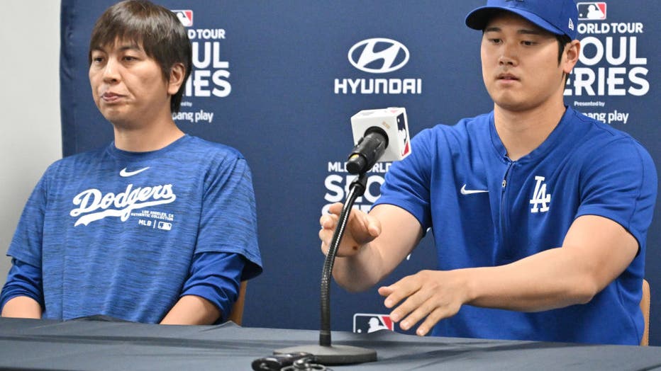 This picture taken on March 16, 2024 shows Los Angeles Dodgers' Shohei Ohtani (R) and his interpreter Ippei Mizuhara (L) attending a press conference at Gocheok Sky Dome in Seoul ahead of the 2024 MLB Seoul Series baseball game between Los Angeles Dodgers and San Diego Padres. The Los Angeles Dodgers said on March 21 they had fired Shohei Ohtani's interpreter after the Japanese baseball star's representatives claimed he had been the victim of "a massive theft" reported to involve millions of dollars. (Photo by Jung Yeon-je / AFP) (Photo by JUNG YEON-JE/AFP via Getty Images)