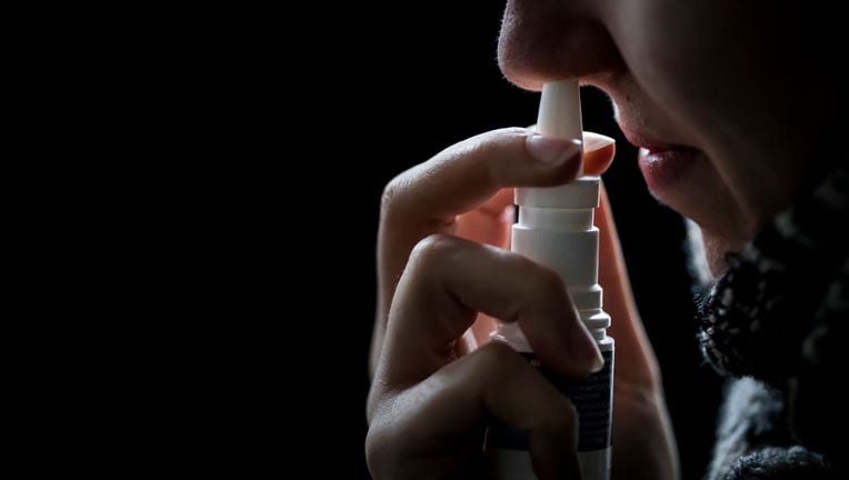 FILE - A woman uses nasal spray on Feb. 5, 2019, in Berlin, Germany. (Photo Illustration by Florian Gaertner/Getty Images)