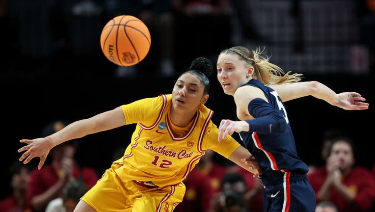 Paige Bueckers #5 of the Connecticut Huskies breaks up a pass intended for JuJu Watkins #12 of the USC Trojans during the second half in the Elite 8 round of the NCAA Women's Basketball Tournament at Moda Center on April 01, 2024 in Portland, Oregon. (Photo by Steph Chambers/Getty Images)