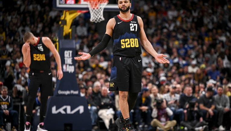 Jamal Murray (27) of the Denver Nuggets looks to the bench as Nikola Jokic (15) wipes sweet from his face as they trail the Los Angeles Lakers during the third quarter at Ball Arena in Denver on Monday, April 22, 2024. (Photo by AAron Ontiveroz/The Denver Post)