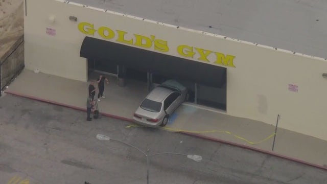 Suspect allegedly in stolen car crashes into Gold's Gym
