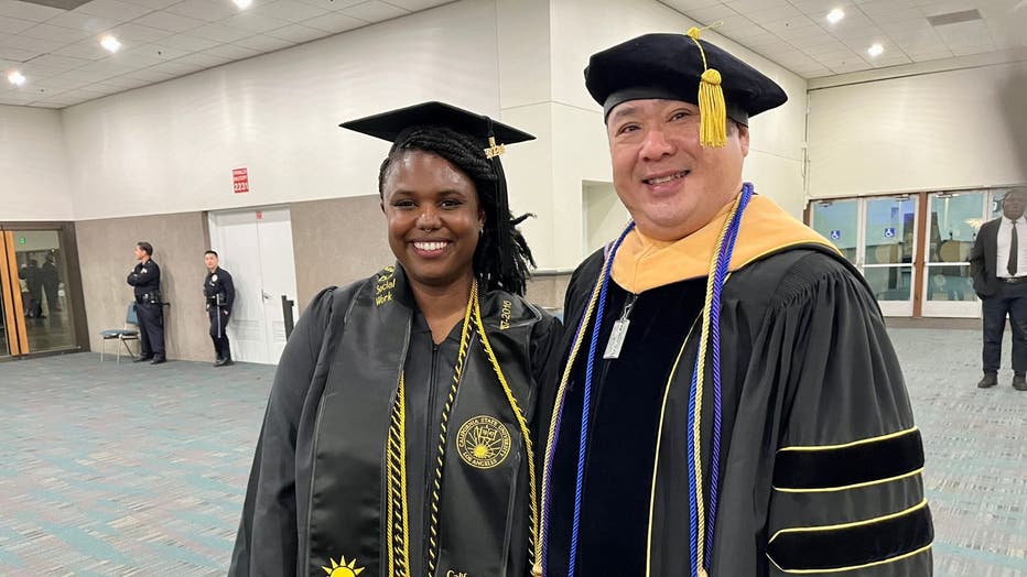 A CSULA graduate and CSULA professor in graduation regalia